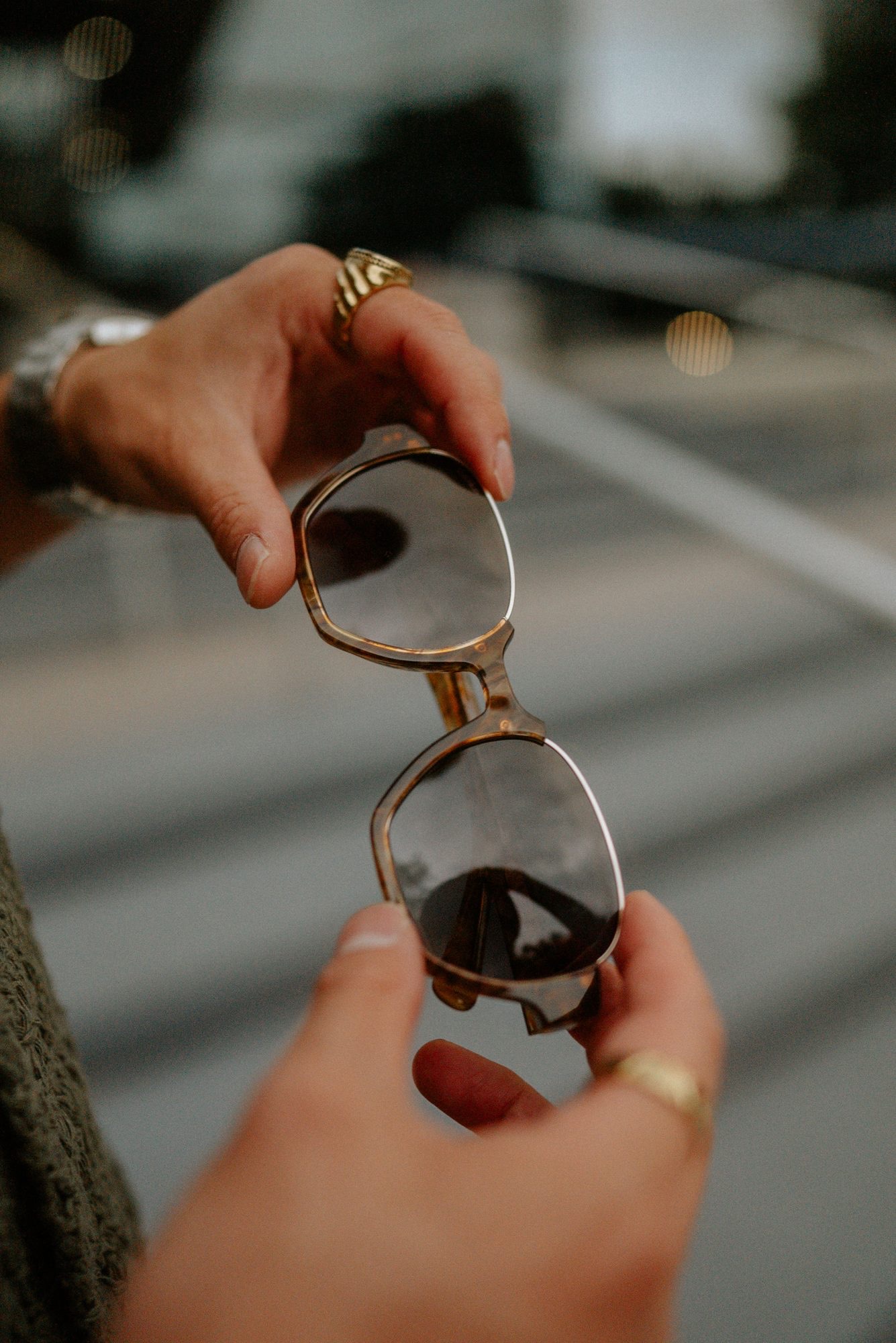 Holding vintage tortoiseshell sunglasses