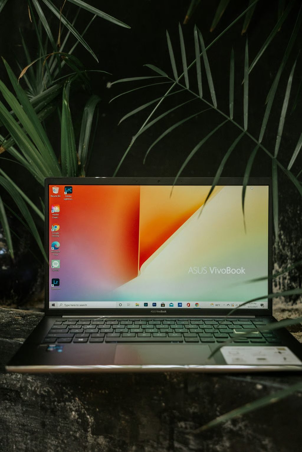 Editing a sunset cityscape photo on a laptop