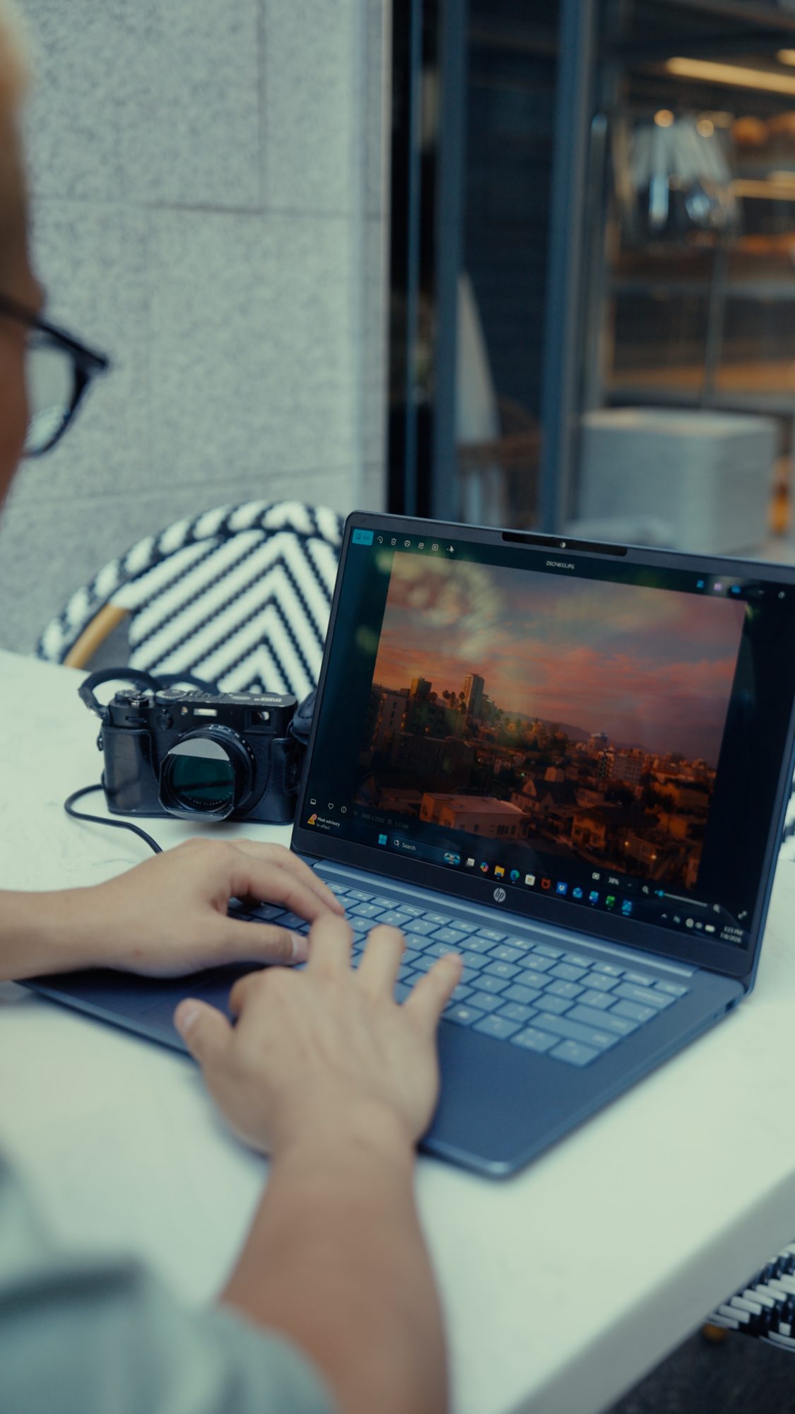 Reviewing a photo next to a Fujifilm camera on a laptop