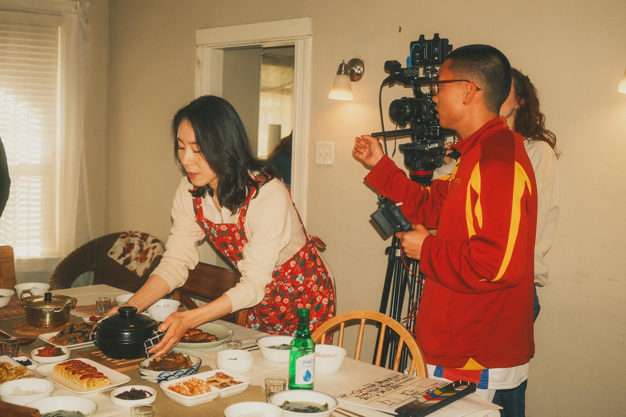 Filming a home-cooked meal setup with slate and crew