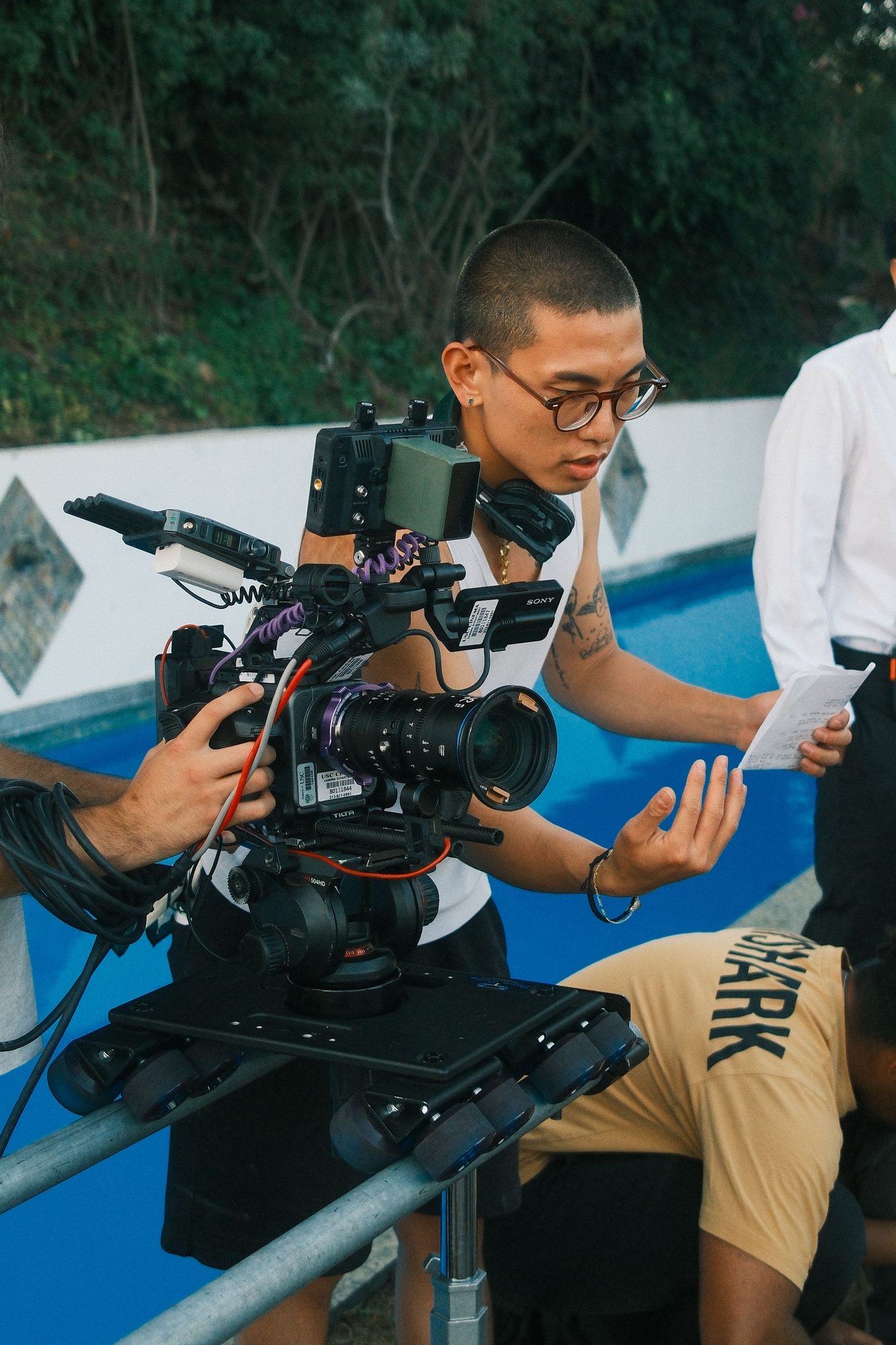 Operating a cinema camera rig poolside on set